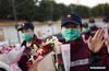 Medics supporting virus-hit Hubei Province wave to greeters after arriving in Xi'an, northwest China's Shaanxi Province, March 17, 2020. Medical assistance teams started leaving Hubei Province early on Tuesday as the epidemic outbreak in the hard-hit province has been subdued. (Xinhua/Li Yibo)