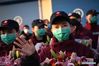 Medics supporting virus-hit Hubei Province wave to greeters upon arrival in Xi'an, northwest China's Shaanxi Province, March 17, 2020. Medical assistance teams started leaving Hubei Province early on Tuesday as the epidemic outbreak in the hard-hit province has been subdued. (Xinhua/Li Yibo)