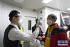 3月29日，在湖北襄阳刘集机场，工作人员在登机前为旅客进行体温检测。 当日，湖北省除武汉天河机场外其他机场国内客运航班恢复。 新华社发（谢剑飞 摄）