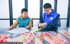 Students in Rugao, East China's Jiangsu province, learn the basics of kite-making, a historical cultural heritage, on March 29, 2020. [Photo/sipaphoto.com]