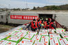 Workers load cases of vegetables onto a freight train at the Fuzhou East Railway Station in Fuzhou, Fujian province, on Feb 17. The 600 metric tons of vegetables were to be transported to Hubei province to support the fight against the novel coronavirus outbreak. ZHANG CHENG/FOR CHINA DAILY