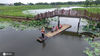 2020年6月19日，游客乘木筏在江苏省南京市高淳区固城湖水慢城景区赏荷游览。