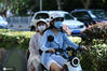 2020年6月30日，江苏南京，南京街头，大部分驾乘电动车市民已经佩戴好头盔。