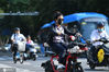 2020年6月30日，江苏南京，南京街头，大部分驾乘电动车市民已经佩戴好头盔。