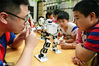 2020年7月21日，在江苏省镇江市风车山社区，江苏大学志愿者在为小朋友讲解机器人的功能。