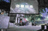  2020年7月28日晩，四川省华蓥市红岩乡茶园村的群众在树荫下一边纳凉一边观看故事片“杀出重围”。