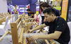 Exhibitors show traditional textile craftsmanship at the Suzhou Creative & Design Cultural Industry Expo in Suzhou, East China's Jiangsu province, July 31, 2020. The 9th China Suzhou Creative & Design Cultural Industry Expo with the theme of 