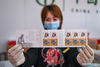 A staff member shows the newly issued special stamps themed on the Year of the Ox in Changchun, northeast China's Jilin Province, Jan. 5, 2021. China Post on Tuesday issued a set of two special stamps to mark the upcoming Year of the Ox. (Xinhua/Zhang Nan)


