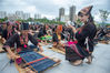 2021年10月16日，在海南省东方市文化广场，千名身着传统服装的黎族妇女熟练织黎锦秀技艺。