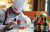 A chef prepares dishes during a Sichuan cuisine skills competition in Chengdu, capital of southwest China's Sichuan Province, Oct. 18, 2021. The 2021 World Sichuan Cuisine Conference kicked off on Monday in Pidu District of Chengdu City, during which chefs show the trending culinary skills of Sichuan cuisines. (Xinhua/Jiang Hongjing)