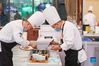 Chefs prepare dishes during a Sichuan cuisine skills competition in Chengdu, capital of southwest China's Sichuan Province, Oct. 18, 2021. The 2021 World Sichuan Cuisine Conference kicked off on Monday in Pidu District of Chengdu City, during which chefs show the trending culinary skills of Sichuan cuisines. (Xinhua/Jiang Hongjing)