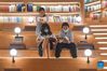 People read books at the Wormhole Library in the Haikou Bay in Haikou, south China's Hainan Province, Oct. 1, 2021. (Xinhua/Pu Xiaoxu)