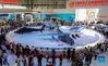 Visitors view exhibits during the 13th China International Aviation and Aerospace Exhibition, or Airshow China 2021, in Zhuhai, south China's Guangdong Province, Oct. 1, 2021. (Xinhua/Liu Dawei)