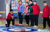 A student throws a curling rock. (People’s Daily Online/Ding Genhou)