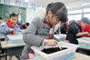 Students from Lujia town, Kunshan try their hands at planting vegetable seeds on March 11. [Photo/IC]