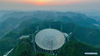 Aerial photo taken on March 29, 2021 shows China's Five-hundred-meter Aperture Spherical radio Telescope (FAST) at sunset in southwest China's Guizhou Province. FAST has identified over 300 pulsars so far. Located in a naturally deep and round karst depression in southwest China's Guizhou Province, it officially began operating on Jan. 11, 2020. (Xinhua/Ou Dongqu)