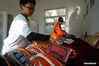 Tseng Chun-an (R) and a student arrange the baseball gloves after a baseball training session in Xinji Center Primary School in Yizheng, east China's Jiangsu Province, April 9, 2021. Born in a 