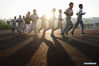 Students warms up before a baseball training session in Xinji Center Primary School in Yizheng, east China's Jiangsu Province, April 9, 2021. Born in a 