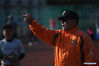 Tseng Chun-an (R) gestures during a baseball training session in Xinji Center Primary School in Yizheng, east China's Jiangsu Province, April 9, 2021. Born in a 