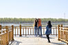 Tourists visit a waterfront promenade in Fengnan District of Tangshan, north China's Hebei Province, April 14, 2021. Fengnan District authorities have taken steps to advance a holistic urban water management program in recent years. The program aims at shaping a sound environment for life improvement, industrial development, and refinement of the urban landscape. (Xinhua/Mu Yu)
