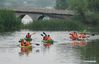 Tourists kayak at Qinhu Lake in Taizhou, east China's Jiangsu Province, on April 27, 2021. Local authorities in Taizhou City have been promoting sports tourism by building sports centers in wetlands, ball games centers, physical development training camps and other sports venues to boost local tourism market. (Xinhua/Yang Lei)