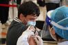 A health worker administers a dose of Sinovac COVID-19 vaccine to a foreign recipient at a vaccination site in Tsinghua University, Beijing, April 3, 2021. [Xinhua/Chen Zhonghao]