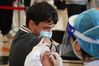 A health worker administers a dose of Sinovac COVID-19 vaccine to a foreign recipient at a vaccination site in Tsinghua University, Beijing, April 3, 2021. [Xinhua/Chen Zhonghao]