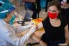 A health worker administers a dose of Sinovac COVID-19 vaccine to Anna Lujza Honecz from Hungary at a vaccination site in Tsinghua University, Beijing, April 3, 2021. [Xinhua/Chen Zhonghao]