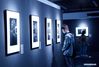 People visit a photo exhibition on Nanjing Massacre survivors at the Memorial Hall of the Victims in Nanjing Massacre by Japanese Invaders, in Nanjing, east China's Jiangsu Province. The exhibition kicked off here on Sunday. (Photo by Sun Zhongnan/Xinhua)