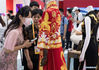 A visitor views a Qipao (cheongsam) on display in the Provinces, Municipalities, Autonomous Regions of China Exhibition Hall during the first China International Consumer Products Expo in Haikou, capital of south China's Hainan Province, May 9, 2021. (Xinhua/Jin Liwang)