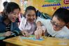 Zhou Wenqing plays games with children at a special education school in Nanjing, east China's Jiangsu Province, May 16, 2019. Zhou Wenqing, a blind student from Nanjing Normal University of Special Education, recently received a tentative offer from Renmin University of China to pursue a master's degree in Applied Psychology. Born in 1998, Zhou Wenqing left hometown at the age of eight to pursue study opportunities alone. In 2017, she was admitted to Nanjing Normal University of Special Education to study Applied Psychology. Confronting the challenges that ordinary students could not imagine, Zhou still made her four-year college life rich and colorful. She passed through CET-6 exam, won the National Scholarship, the National Inspirational Scholarship and so on. Academically, she has kept being on the top of the list. After class, Zhou Wenqing studied broadcasting and has hosted for several times. Knowledge lights up the night sky. Zhou Wenqing uses her knowledge and warm heart to enlighten more hearts. She presided over a provincial key entrepreneurial project, developing a learning APP and a series of courses for disabled people. She also volunteered to be a teaching assistant at 