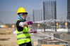 A worker is busy at the construction site of a smart factory in the economic and technological development zone in Yinchuan City, northwest China's Ningxia Hui Autonomous Region, May 1, 2021. People from various sectors stick to their posts during the Labor Day holiday. (Xinhua/Feng Kaihua)