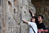 Tourists visit the 1,500-year-old Gongyi Grotto Temple in China’s Henan Province, May 23, 2021. The Gongyi Grotto Temple was first established in the Northern Wei Dynasty(386?534). It now comprises five caves, one shrine, three large cliff-face Buddha statues, 7,743 Buddhist statues and more than 200 stone inscriptions. (China News Service/Zhang Xinglong)