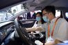 People try an electric vehicle using the BeiDou Navigation Satellite System (BDS) at an exhibition featuring satellite navigation achievements during the 12th China Satellite Navigation Conference (CSNC 2021) in Nanchang, capital of east China's Jiangxi Province. The 12th China Satellite Navigation Conference (CSNC 2021) kicked off here on Wednesday, highlighting the role of spatiotemporal data. The three-day conference focuses on the most recent technological and industrial application achievements of the BeiDou Navigation Satellite System (BDS) and development trends of global navigation satellite systems (GNSS). (Xinhua/Peng Zhaozhi)