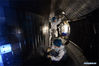 Staff members perform an upgrade to the experimental advanced superconducting tokamak (EAST) at the Hefei Institutes of Physical Science under the Chinese Academy of Sciences (CAS) on April 28, 2021. Chinese scientists have set a new world record of achieving a plasma temperature of 120 million degrees Celsius for a period of 101 seconds in the latest experiment on Friday, a key step toward the test running of a fusion reactor. The experiment at the experimental advanced superconducting tokamak (EAST), or the 