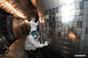 Staff members perform an upgrade to the experimental advanced superconducting tokamak (EAST) at the Hefei Institutes of Physical Science under the Chinese Academy of Sciences (CAS) on April 28, 2021. Chinese scientists have set a new world record of achieving a plasma temperature of 120 million degrees Celsius for a period of 101 seconds in the latest experiment on Friday, a key step toward the test running of a fusion reactor. The experiment at the experimental advanced superconducting tokamak (EAST), or the 