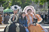 A tourist, center, poses for a group photo with performers at the Italian Style Area in Hebei District of North China's Tianjin on May 1, 2021. The area held its first public reception day after an overall upgrade. Many tourists took advantage of the May Day holiday to visit the area. [Photo/Xinhua]