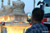 A tourist takes a photo while sightseeing in Hohhot, north China's Inner Mongolia Autonomous Region, June 10, 2021. Various activities such as appreciating traditional music and tasting local food are held here to promote tourism. (Xinhua/Bei He)