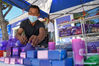 A vender arranges products made of lavender in Huocheng County, northwest China's Xinjiang Uygur Autonomous Region, June 13, 2021. (Xinhua/Ding Lei)