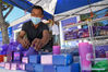 A vender arranges products made of lavender in Huocheng County, northwest China's Xinjiang Uygur Autonomous Region, June 13, 2021. (Xinhua/Ding Lei)