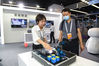 A staff member of Baidu Inc, an internet company, introduces AI teaching experiment platform to a visitor at the future network innovative exhibition in Nanjing, Jiangsu province, on June 17, 2021. [Photo/Xinhua]