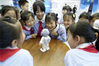 Students from a primary school watch a robotic performance at the Liangjiang Robot Exhibition Center in Chongqing's Beibei district on May 31. The visit, organized by a local community to mark International Children's Day, which fell on Tuesday, was aimed at popularizing science and technology among children. [Qin Tingfu/Xinhua]