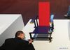 A visitor takes photos of an artwork by Gerrit Thomas Rietveld at an exhibition in Tsinghua University Art Museum in Beijing, capital of China, June 3, 2021. Displaying a total of 158 modern designs, the exhibition named 