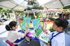Children paint during the media open day of the Greater Bay Area Shenzhen Flower Show in Shenzhen, South China's Guangdong province, on March 19, 2021. [Photo/Xinhua]