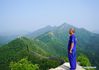 Zhang Heshan enjoys the scenery of the Zhengguanling Great Wall in Qinhuangdao, north China's Hebei Province, July 7, 2021. Zhang Heshan, 66, is a villager of Chengziyu, where lies a section of China's Great Wall dating back to Ming Dynasty (1368-1644). Since 1978, Zhang has been a protector of the Great Wall. Over the years, he patrolled the wild Great Wall near his village and never been held back by various challenges, such as blizzards, rainstorms, wild bees and snakes. He has persuaded the herdsmen to leave, scared away the brick-stealers, stopped tourists from making carvings on the Wall, and reported damages. 