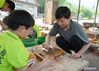 Zhang Heshan shows the published photo of the Great Wall in Chengziyu Village, Qinhuangdao, north China's Hebei Province, July 7, 2021. Zhang Heshan, 66, is a villager of Chengziyu, where lies a section of China's Great Wall dating back to Ming Dynasty (1368-1644). Since 1978, Zhang has been a protector of the Great Wall. Over the years, he patrolled the wild Great Wall near his village and never been held back by various challenges, such as blizzards, rainstorms, wild bees and snakes. He has persuaded the herdsmen to leave, scared away the brick-stealers, stopped tourists from making carvings on the Wall, and reported damages. 