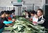 Villagers process lotus leaves to make tea at a workshop in Linhuai Town of Sihong County, east China's Jiangsu Province, July 14, 2021. (Photo by Xu Changliang/Xinhua)