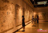 Visitors look at Dunhuang Frescoes at China Three Gorges Museum in Chongqing, July 15, 2021. (Photo/Zhou Yi)