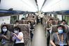 Visitors experience for themselves inside a cabinet of China's new high-speed maglev train in Qingdao, east China's Shandong Province, July 20, 2021. China's new high-speed maglev train rolled off the production line on Tuesday. It has a designed top speed of 600 km per hour -- currently the fastest ground vehicle available globally. The new maglev transportation system made its public debut in the coastal city of Qingdao, east China's Shandong Province. It has been self-developed by China, marking the country's latest scientific and technological achievement in the field of rail transit, according to the China Railway Rolling Stock Corporation. (Xinhua/Li Ziheng)