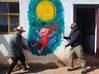 People pose for pictures with a mural in Guanzhong village, Yunnan province. [Photo provided to chinadaily.com.cn]